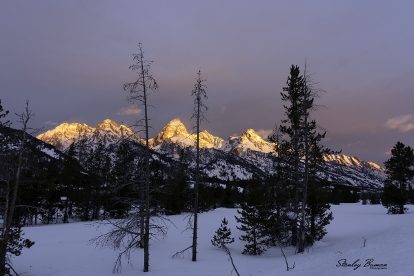 Early morning sunlight shines underneath the clouds and strikes the Teton mountain peaks.  Sony a7R III + 24-105mm lens @24 mm, ISO 800, f/13, 1/25.  ©Stanley Buman.  All Rights Reserved.